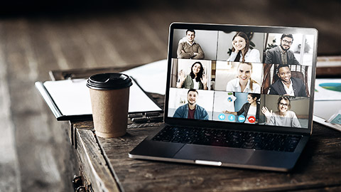 A first person point of view of a laptop video conference with a diverse group in a cafe