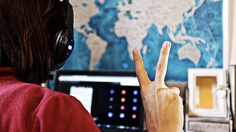 A person making a peace sign on screen