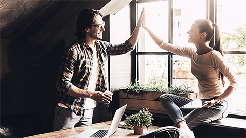 A pair high-fiving each other