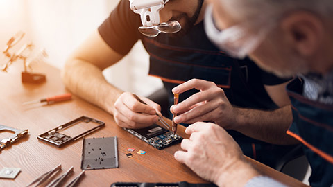 People repairing mobile phones