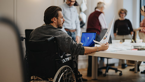 A person in a wheelchair working in an office