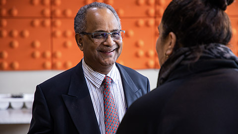 2 staff members talking in an office environment