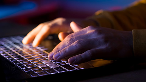 A close view of a person typing on a keyboard