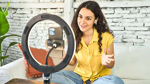 A person using a phone to do a live stream