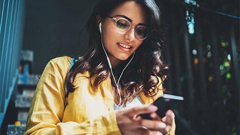 A young person looking at their phone