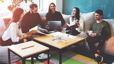 A group of youth workers sitting around in an office space talking about work