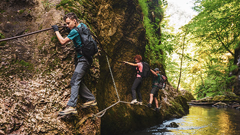 A group of people doing and ropes course along a river