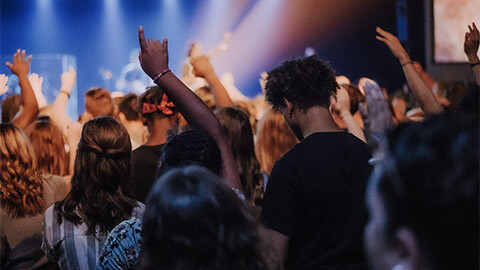 Young people worshipping at their church on a Sunday