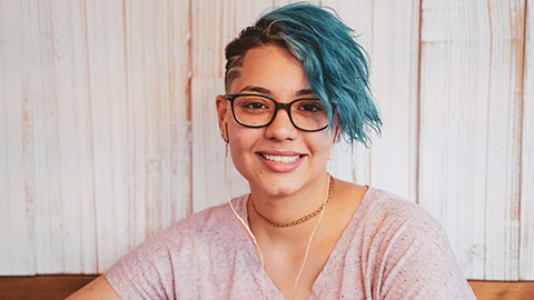 A mid-shot of a smiling teen