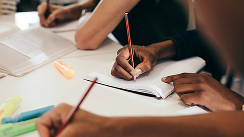 Close view of a group workers writing down activity plans