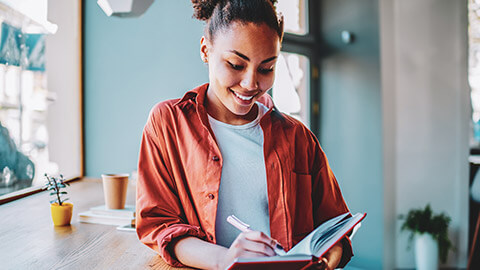 A youth worker writing survey answers in a note pad