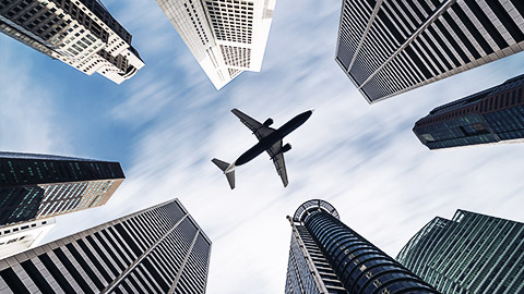 An airplane above buildings