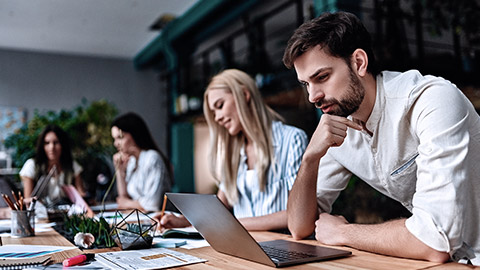 Office workers looking at laptop