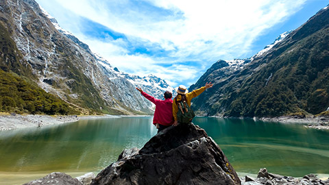 Travelers couple team look on the mountain landscape