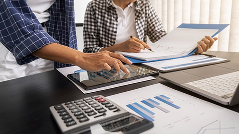 Business team brainstorming and discussing with financial data and report graph