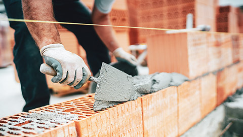 A close view of a brickwork being laid