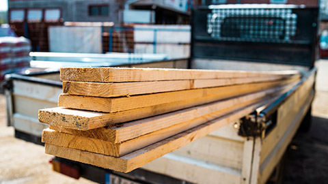 A close view of timber lengths on the back of a utility vehicle