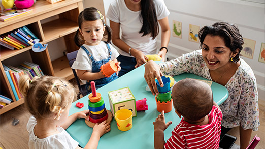 a scene where teacher and preschool students interacting