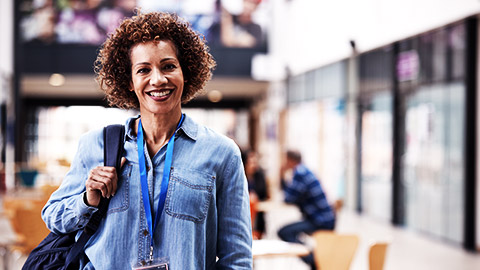 a lady standing there with a lanyard around her neck