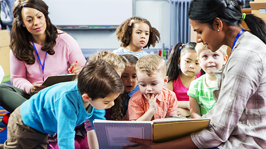 a teacher engaging kids while being supervised