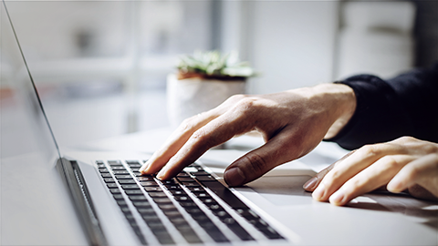 young man's hand using laptop