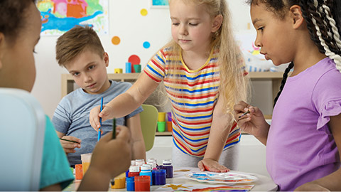 children painting at lesson indoors