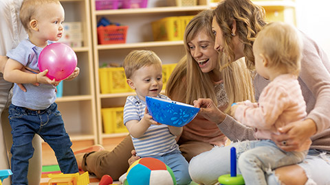 happy moms with their babies in nursery