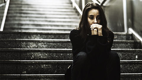 a person Sitting Looking Worried on a  Stairway