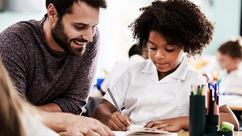 a teacher and a chlid interacting one on one