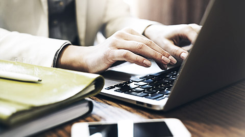 A close up shot of a person using a laptop