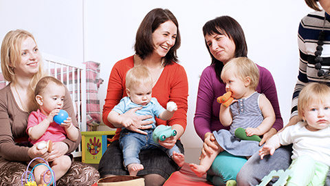 women holding babies