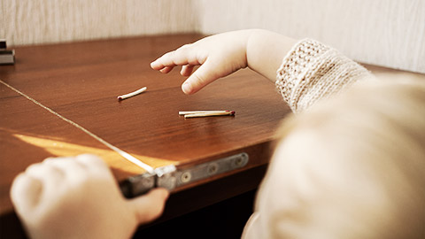 A child reaching on a hazardous item