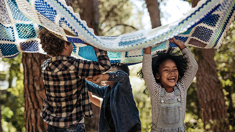 Four children playing blanket outdoor