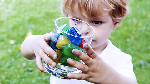 Boy playing with colorful ice cubes