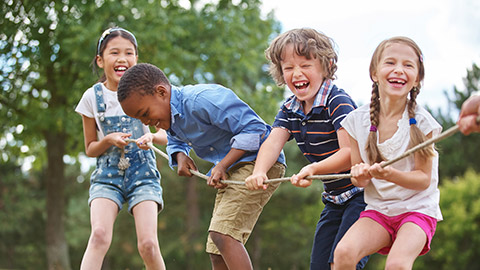 Children playing tug of war at the park