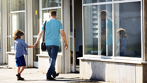 A parent support ing a child to go to a center