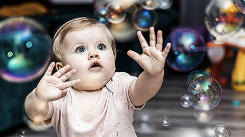 Anexpressive baby amazed by bubbles