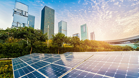 A wide shot of solar panels outside highrise buildings