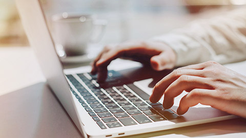 A close view of a person typing on a laptop computer