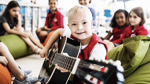 A child with down syndrome having fun with other children