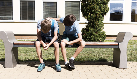 A couple of children consoling their friend