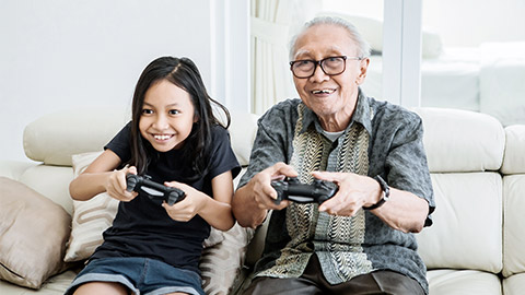 Senior and child playing video games