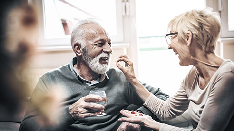 Woman giving medicine to a man