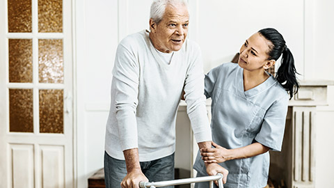 Helping elder man to walk