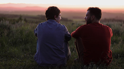 2 friends talking outdoors