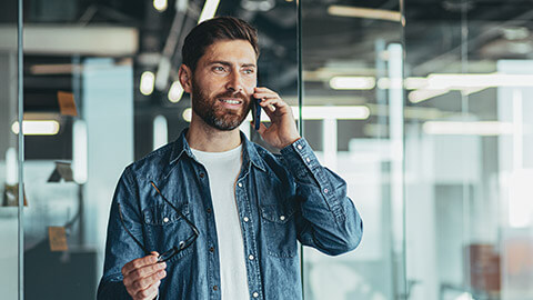 A worker communicating on a mobile phone to someone in another organisation