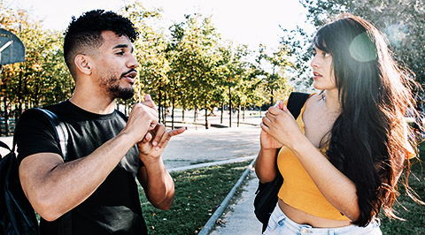 Two people conversing in Auslan