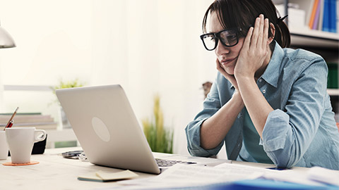 a person frustrated in front of a laptop