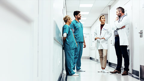 a group of medical professionals talking in the hallway