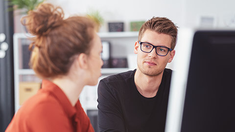 A serious discussion with one person trying to difuse the situation with a pleasant look on their face